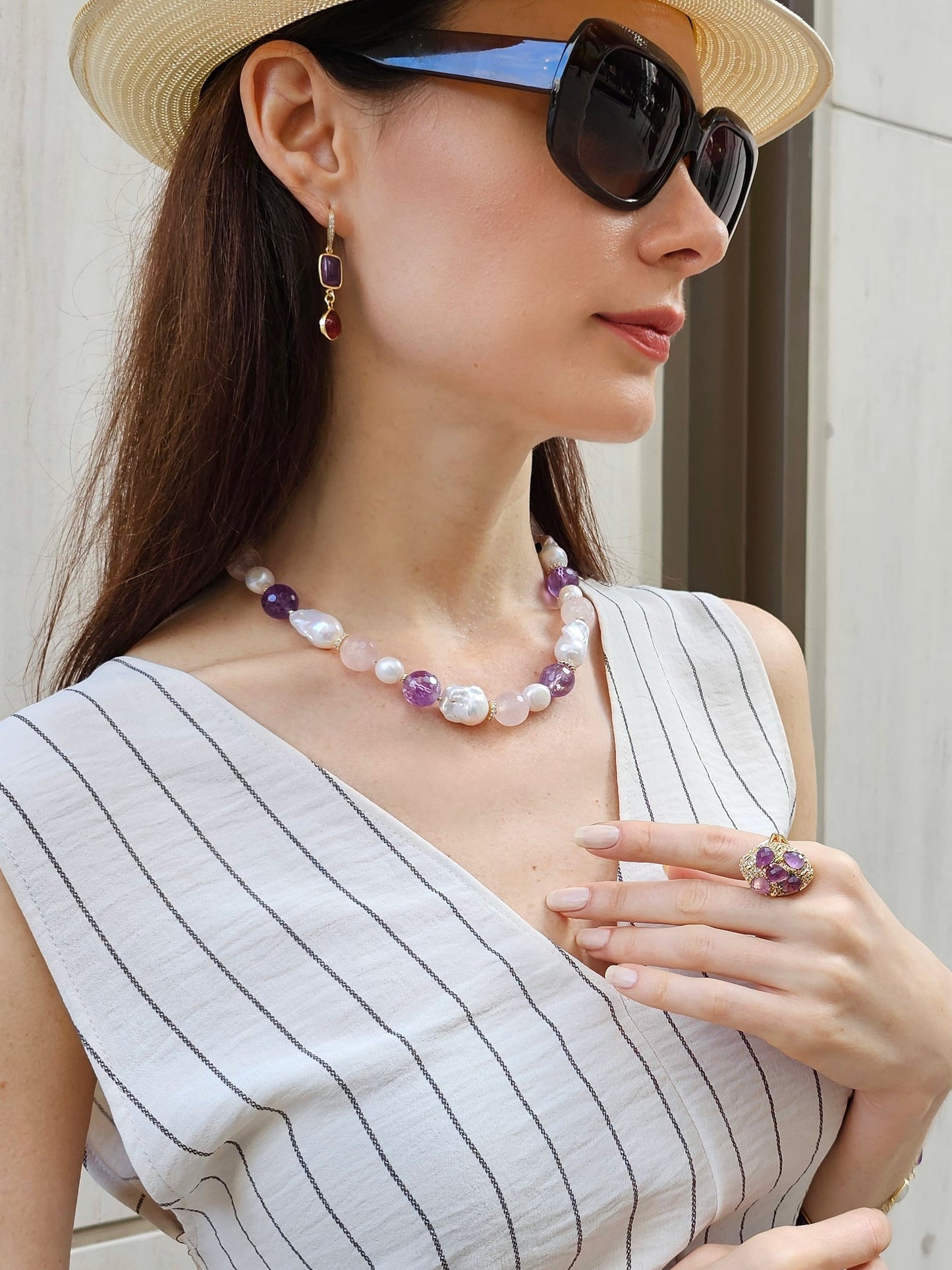 FARRA handmade amethyst jewelry ring worn on hand with matching necklace and earrings