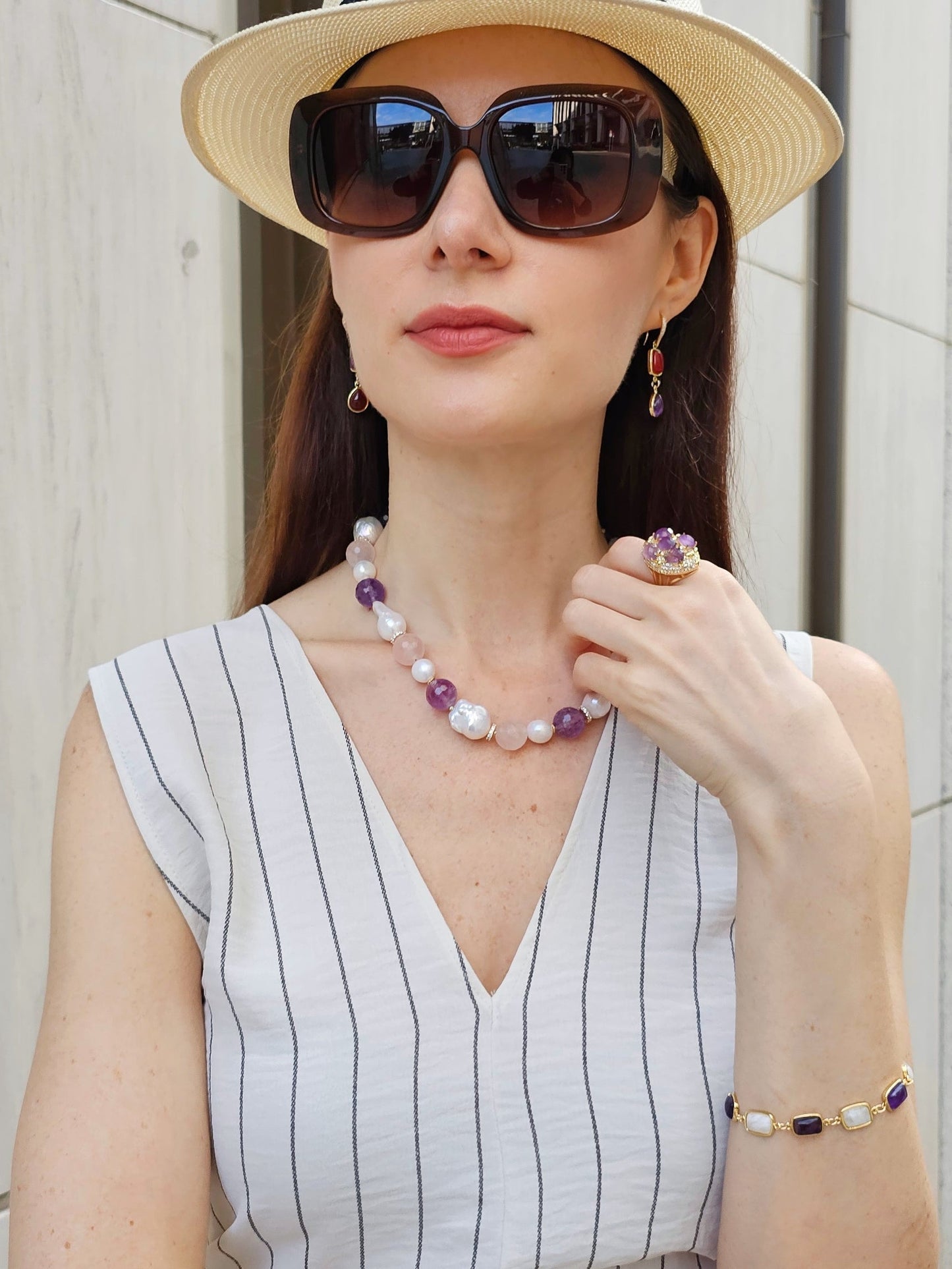 Woman wearing FARRA handmade amethyst jewelry ring along with matching necklace, earrings, and bracelet