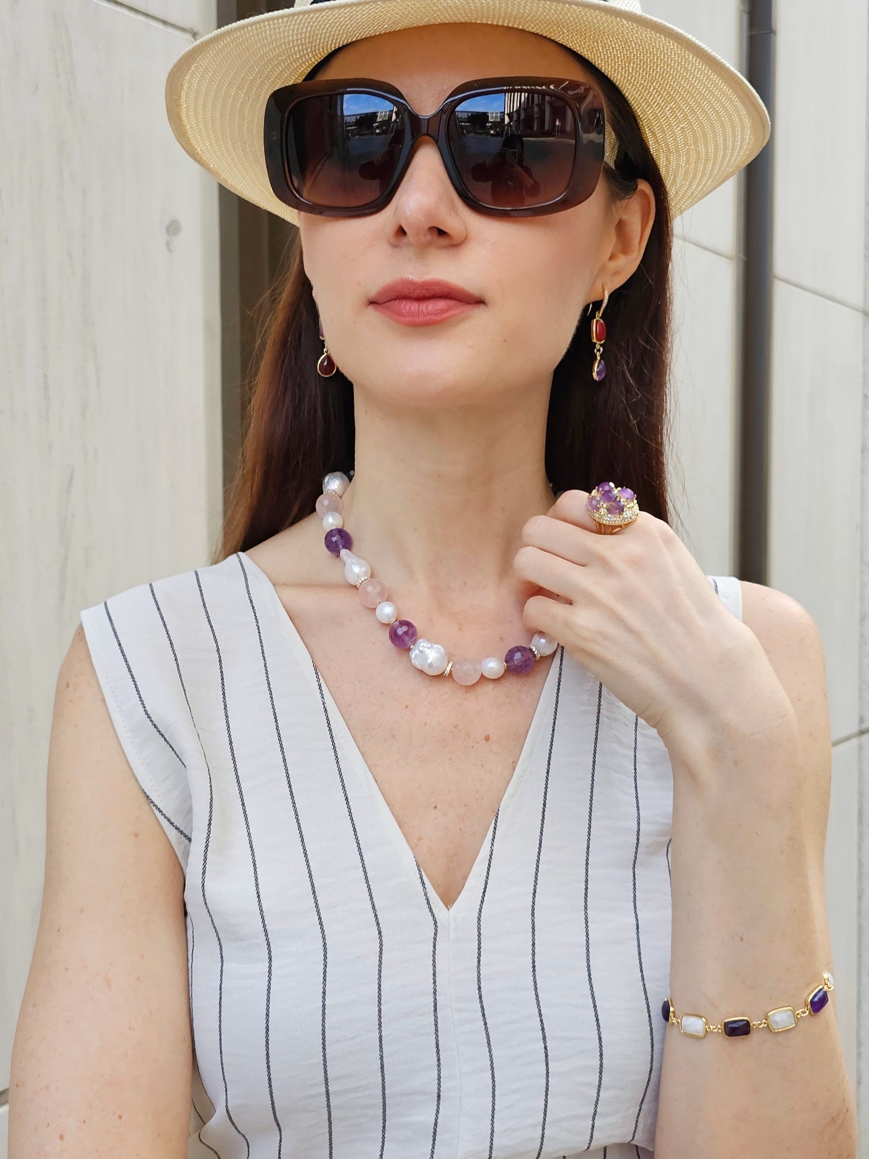 Woman wearing FARRA handmade amethyst jewelry ring along with matching necklace, earrings, and bracelet