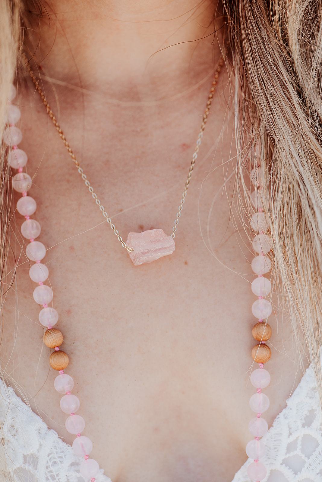 Kuratif handmade crystal necklace with a raw pink crystal pendant on a delicate gold chain