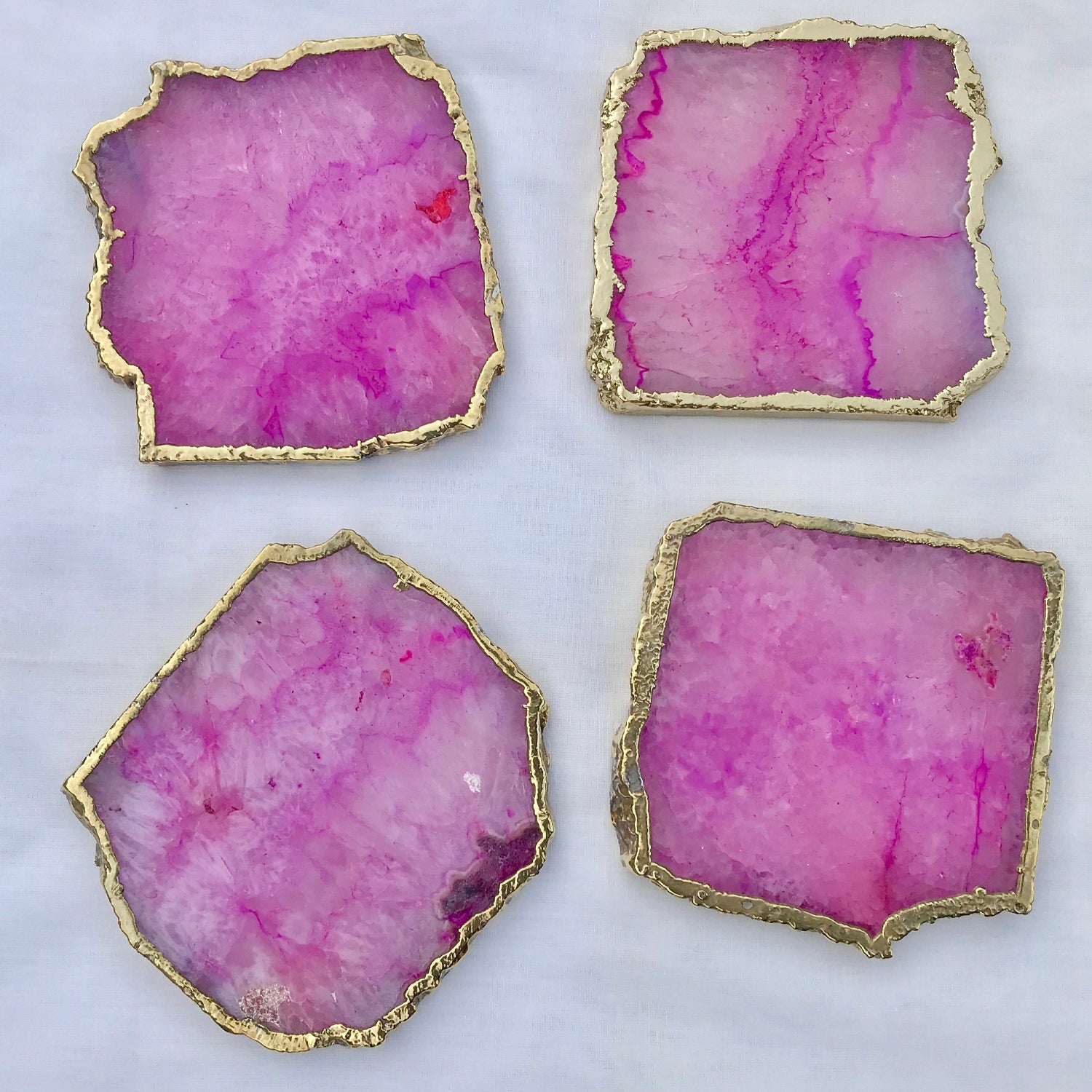 Set of four large pink agate drink coasters with gold edges from The Tangerine Store