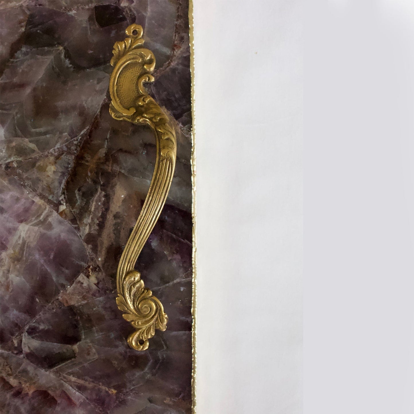 Luxury stone serving platter with a gold ornate handle and contrasting purple and white stone design