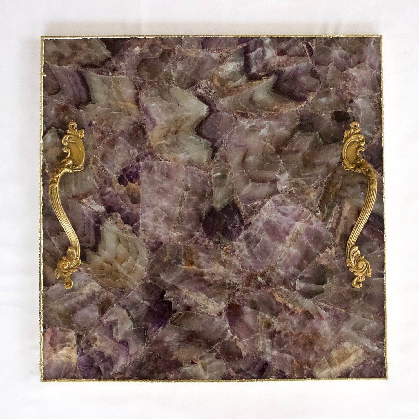 Luxury stone serving platter with gold handles featuring a purple and brown stone pattern