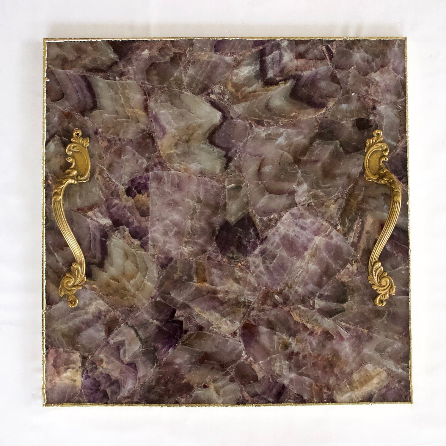 Luxury stone serving platter with gold handles featuring a purple and brown stone pattern